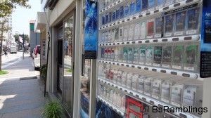 A cigarette vending machine next to a cigarette store