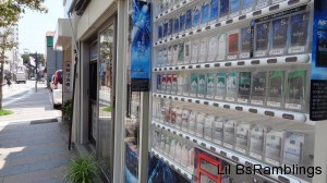 A cigarette vending machine next to a cigarette store