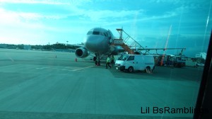 A small passenger plane with a van in front of it