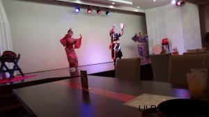 Three dancers, one in eisa gear and two in traditional Japanese female outfits