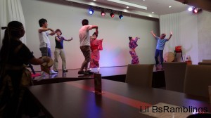 Two lady performers dancing with the audience on stage