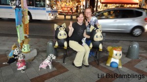 My sister and I posing with baby statues dressed like animals.