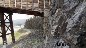 The end of the wooden bridge goes into a short by nearly sheer drop to the riverbed.