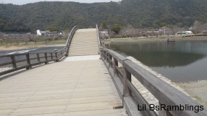 A view next to the wooden railings of the top of the first arch of the bridge.