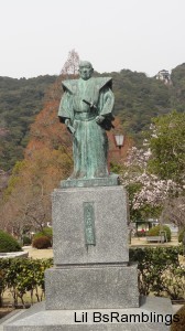 A tarnished brass statue of a 17th century Japanese fuedal lord.