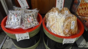 Packets of dried fish in barrels next to each other.