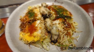 A close up of Okonomi-yaki with oysters in the center.