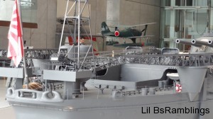 A model of the Yamato showing an airplane about to take off from the back of the ship via a slingshot method.