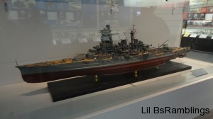 A model battleship behind glass