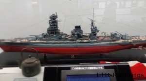 A model Japanese ship behind glass.
