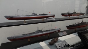 Four model Japanese World War 2 ships behind glass