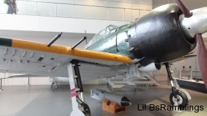 The wing and body of a full-size silver Japanese bomber.