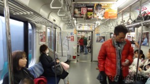 A picture of the inside of the train through a door between cars