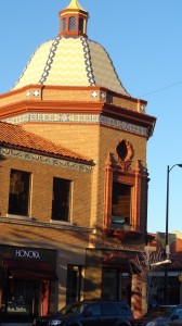 A squat slightly domed tower on a building in Kansas City that almost looks like the adobe coloring of the South Western Uniterd States.